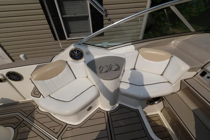 Slide: The Image of 2008 Sea Ray 240 Sundancer boat interior with white seating and cup holders. - 8