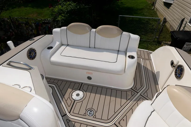 Slide: The Image of 2008 Sea Ray 240 Sundancer boat interior with white seating and teak-style flooring. - 9