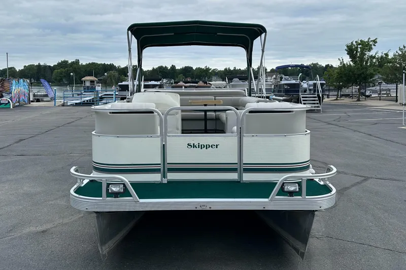 Slide: The Image of Sea Hunt 20 pontoon boat, 2001 model, with canopy, parked on pavement. - 1