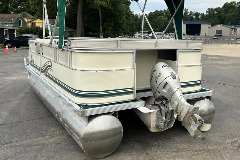 Slide: The Image of 2001 Sea Hunt 20 pontoon boat with outboard motor in parking lot. - 4