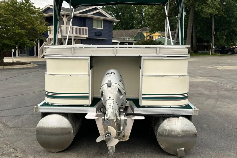 Slide: The Image of 2001 Sea Hunt 20 pontoon boat with outboard motor in a parking lot. - 5