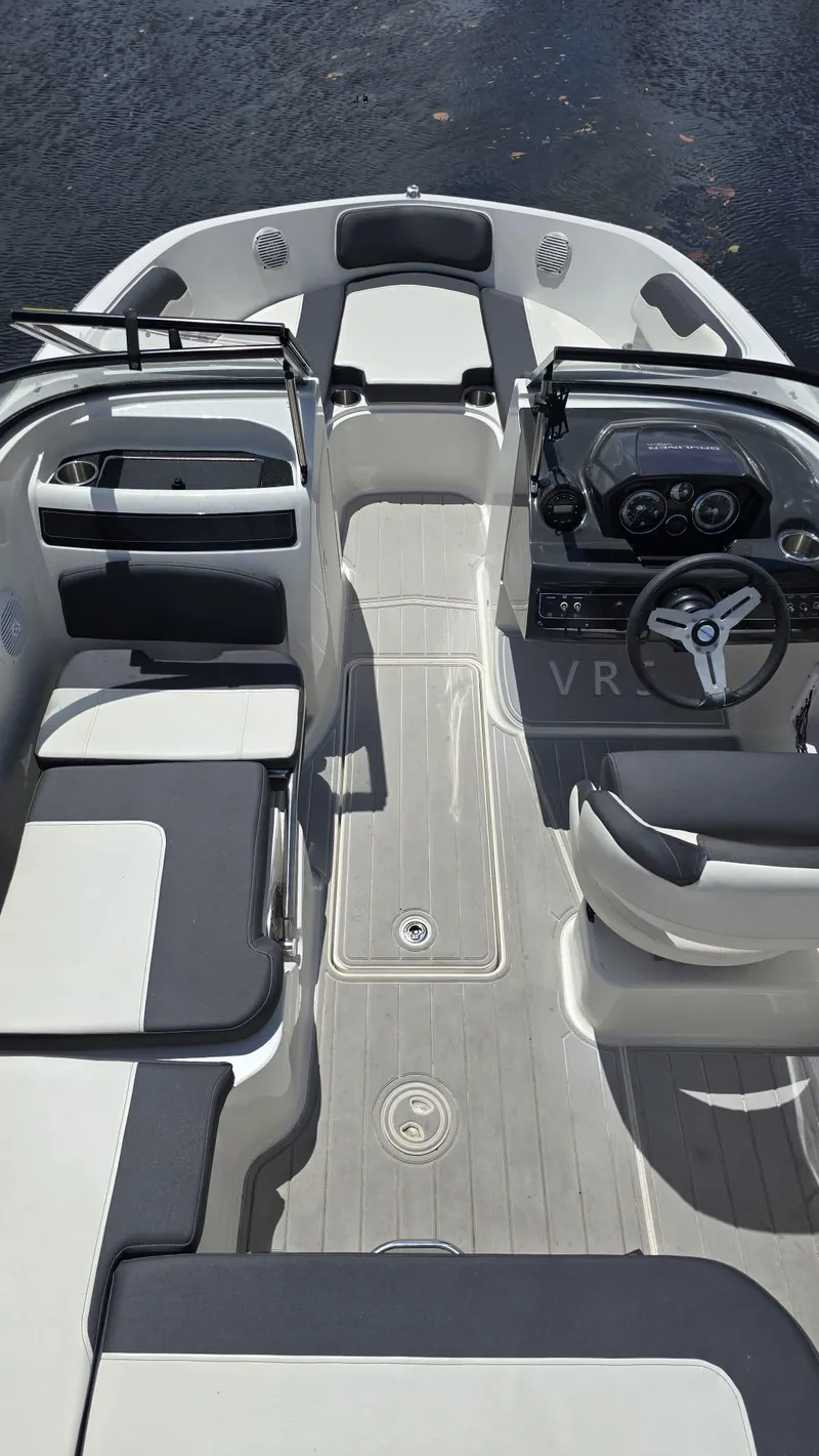 Slide: The Image of 2021 Bayliner VR5 Bowrider OB interior with seating and steering wheel, on water. - 2
