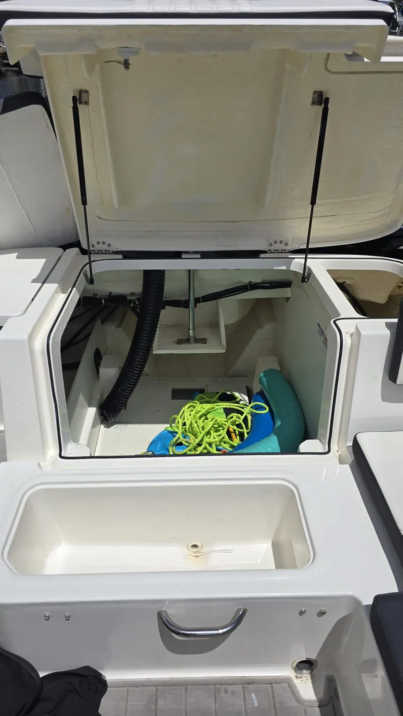 Slide: The Image of 2021 Bayliner VR5 Bowrider OB storage compartment with open hatch and boating gear. - 3