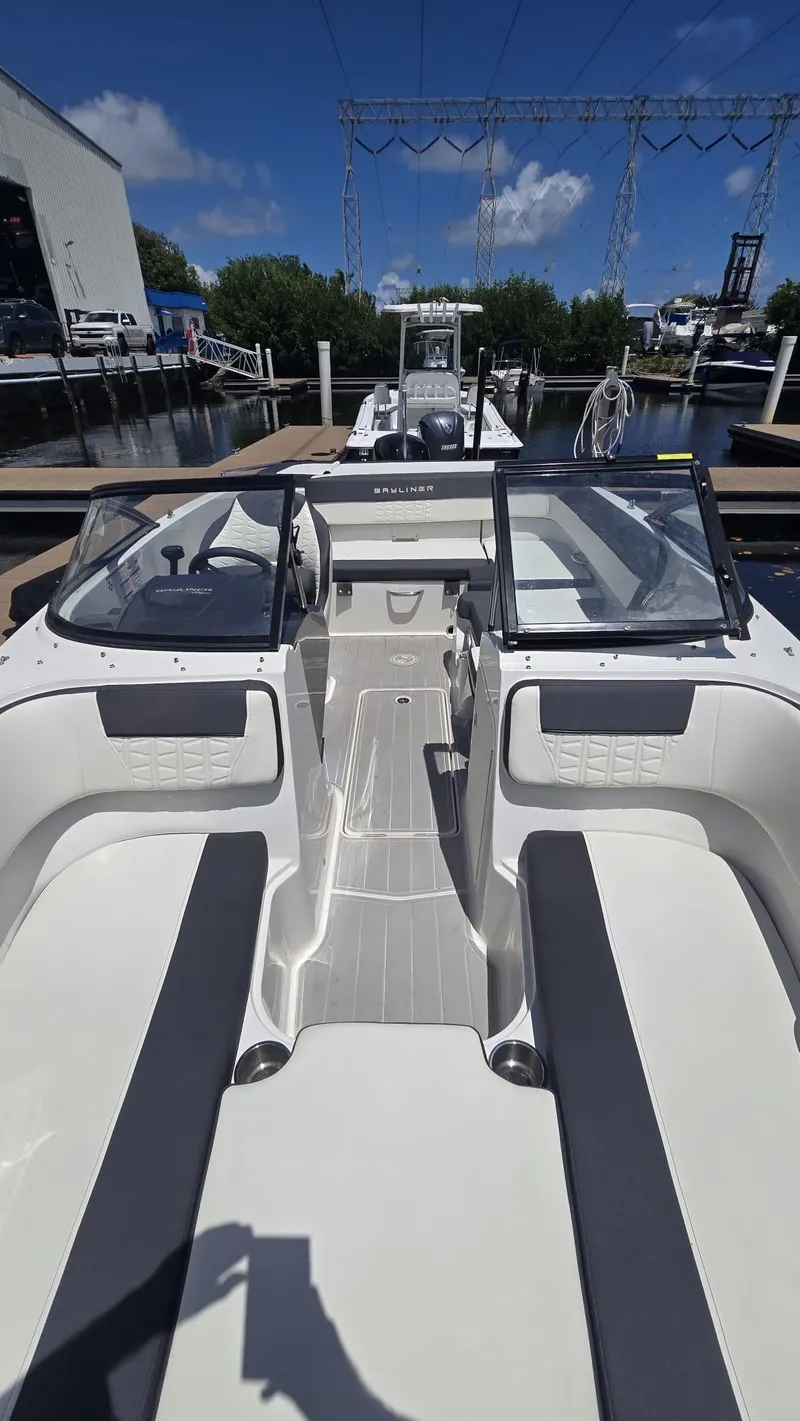 Slide: The Image of 2021 Bayliner VR5 Bowrider OB boat interior with open seating and clear skies. - 4