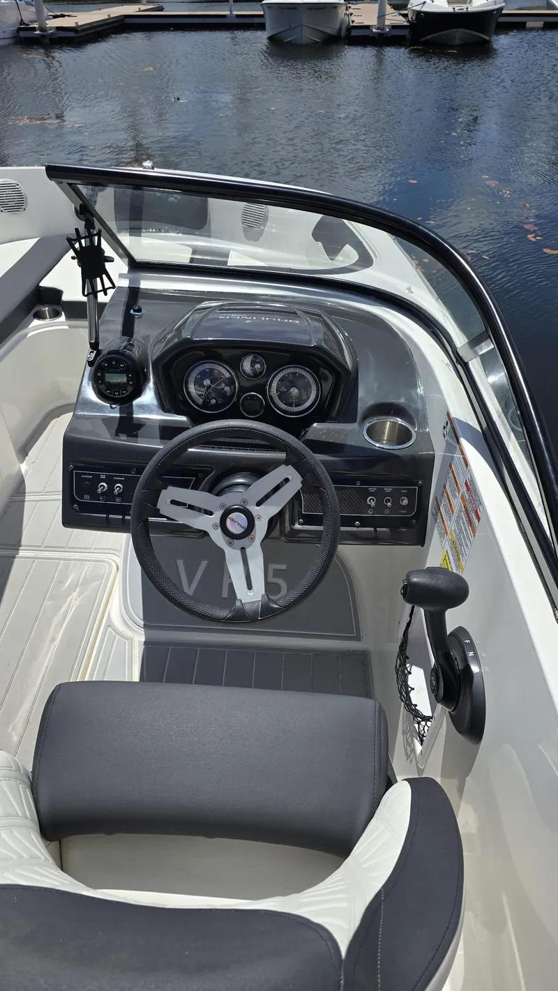 Slide: The Image of 2021 Bayliner VR5 Bowrider OB dashboard and steering wheel at marina. - 5