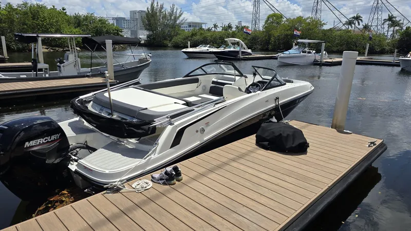 Slide: The Image of 2021 Bayliner VR5 Bowrider OB docked, featuring sleek design and Mercury outboard engine. - 7