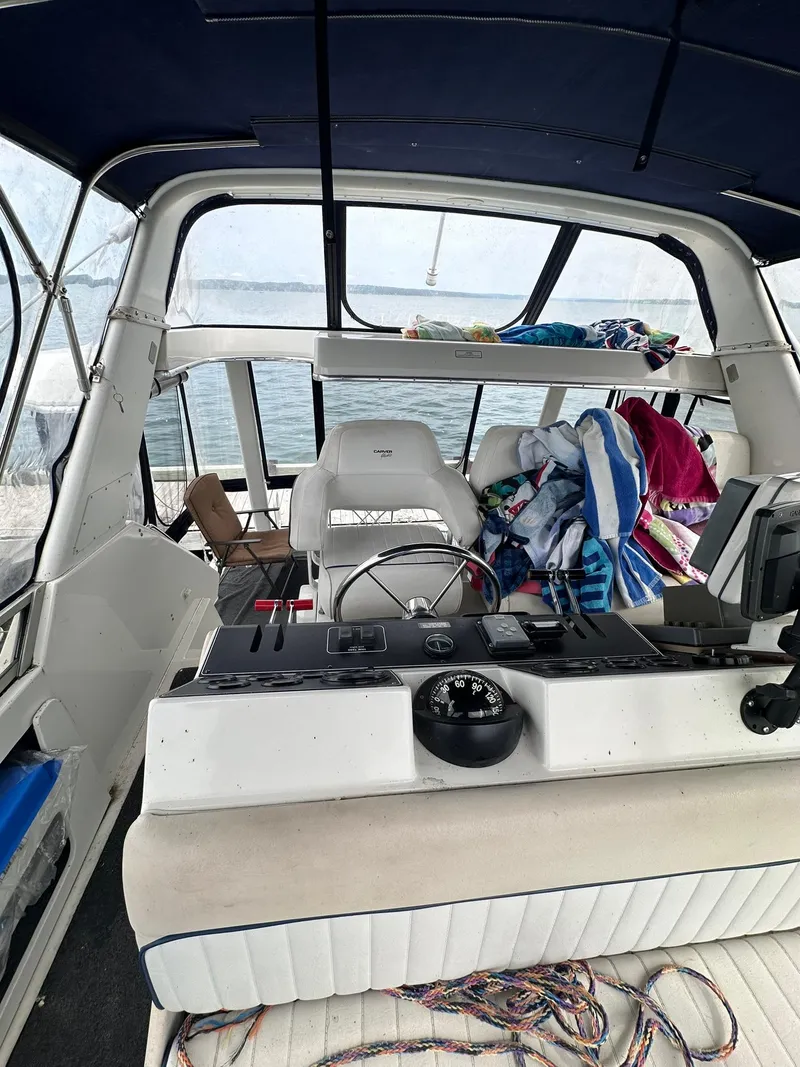 Slide: The Image of 1993 Carver 33 Aft Cabin interior with helm, seating, and nautical equipment. - 10
