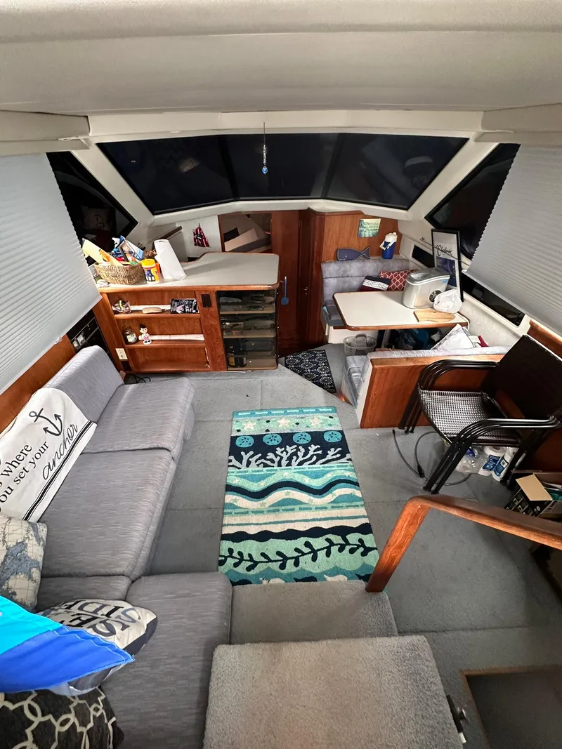 Slide: The Image of Interior of 1993 Carver 33 Aft Cabin with cozy seating and nautical decor. - 13