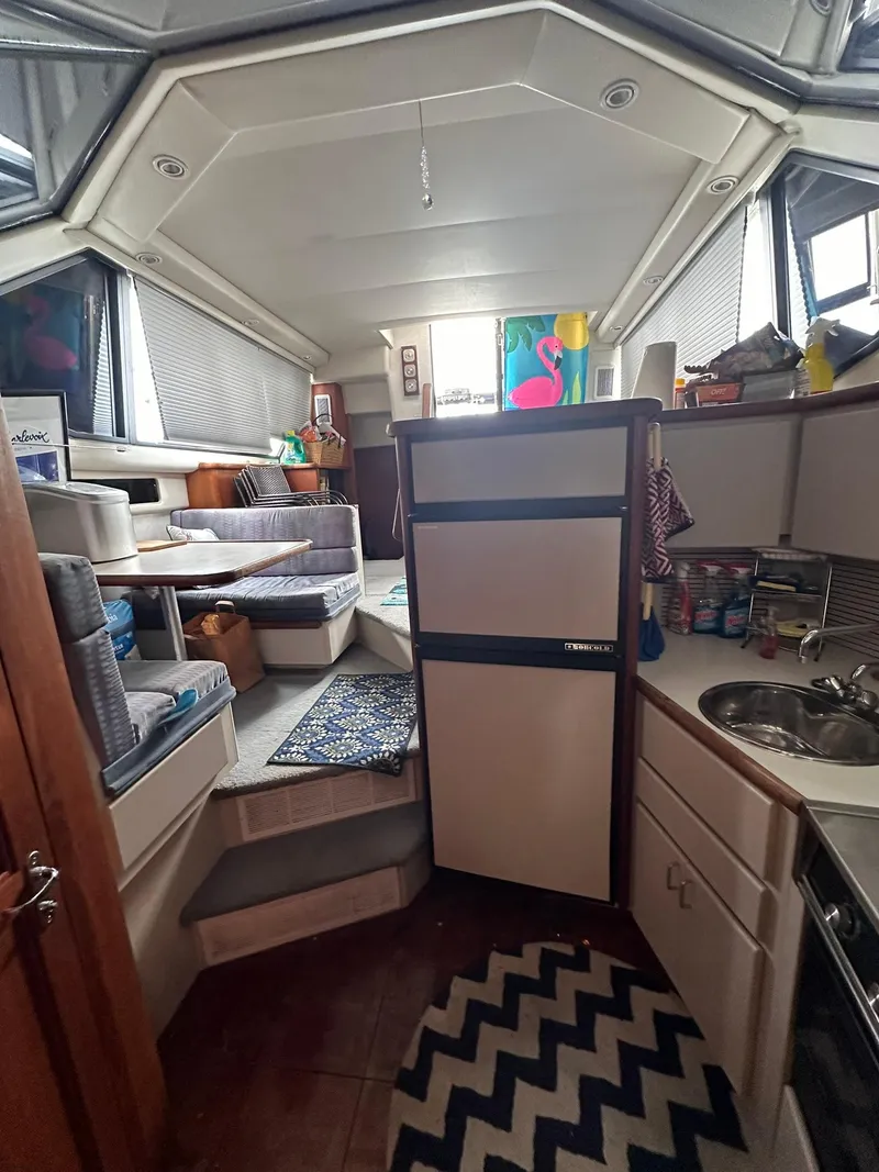 Slide: The Image of Interior of 1993 Carver 33 Aft Cabin with kitchen and seating area. - 16