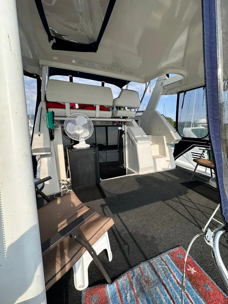 Slide: The Image of 1993 Carver 33 Aft Cabin interior with seating, fan, and carpeted floor. - 5