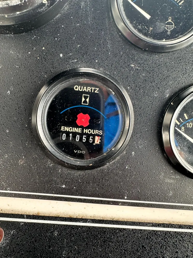 Slide: The Image of Close-up of a 1993 Carver 33 Aft Cabin engine hour meter showing 1055 hours. - 7