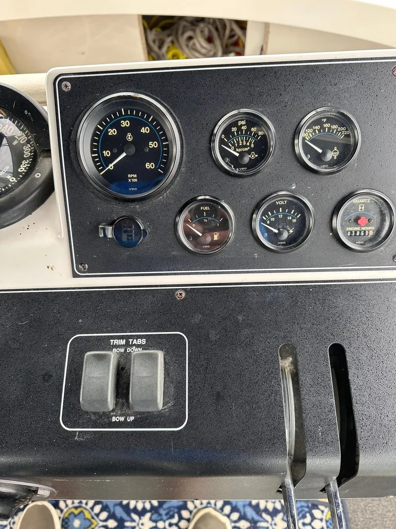 Slide: The Image of Dashboard of a 1993 Carver 33 Aft Cabin boat with gauges and controls. - 9