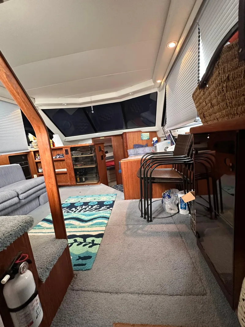 Slide: The Image of Interior of 1993 Carver 33 Aft Cabin with cozy seating and nautical decor. - 14