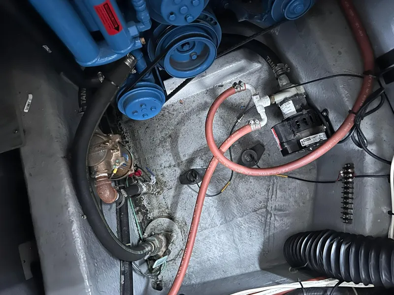 Slide: The Image of Engine compartment of 1993 Carver 33 Aft Cabin with visible hoses and components. - 23