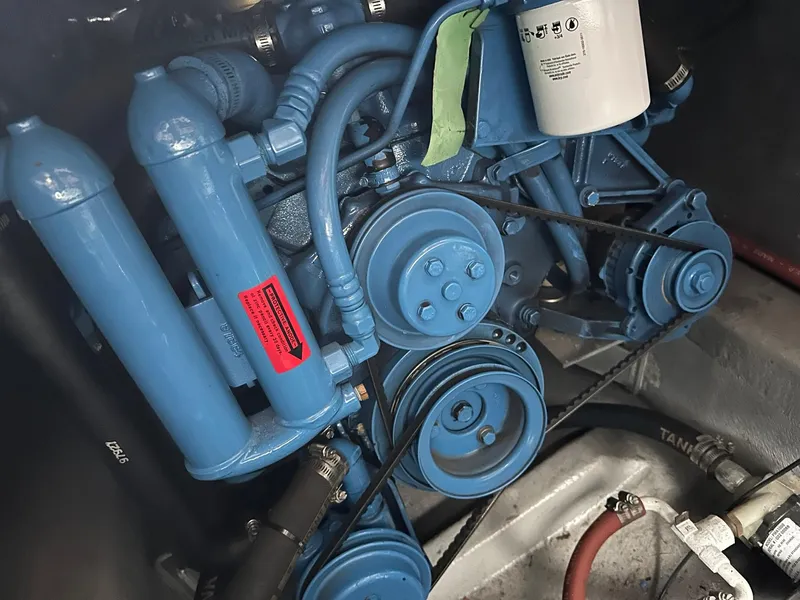 Slide: The Image of Engine compartment of a 1993 Carver 33 Aft Cabin boat, featuring blue components. - 25