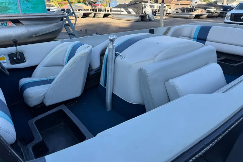 Slide: The Image of 1989 Correct Craft Ski Nautique interior with blue and white seating, parked outdoors. - 10