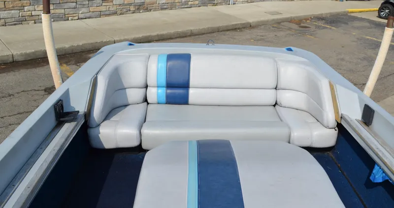 Slide: The Image of 1989 Correct Craft Ski Nautique boat interior with gray and blue seating. - 8