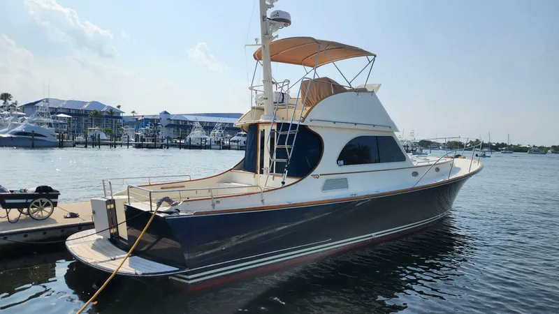 Slide: The Image of 2002 Hinckley Talaria 44 FB yacht docked at marina, sunny day. - 1