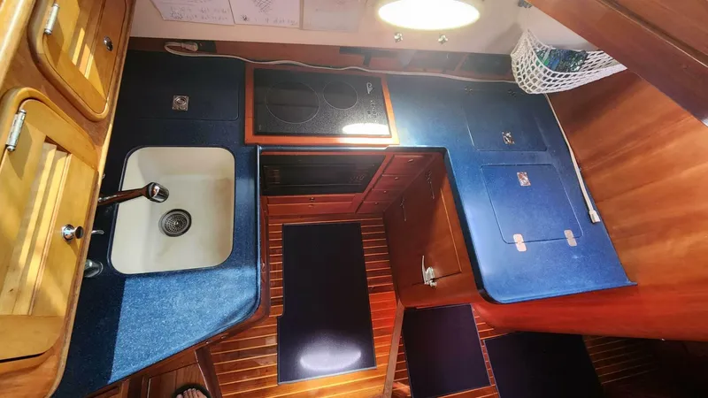 Slide: The Image of Hinckley Talaria 44 FB 2002 yacht kitchen with sink, stove, and wooden cabinetry. - 10