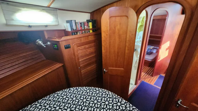 Slide: The Image of Hinckley Talaria 44 FB 2002 yacht interior with wooden cabinetry and patterned bedding. - 14