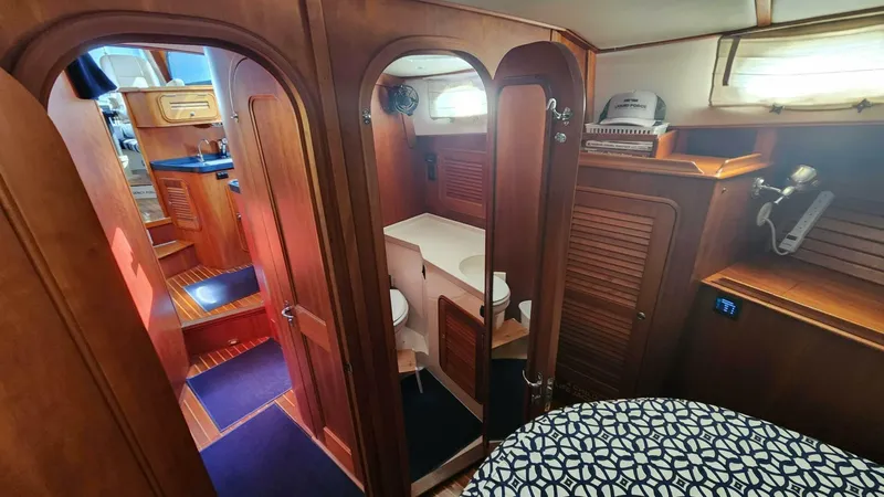Slide: The Image of Hinckley Talaria 44 FB 2002 yacht interior with wood finish and cozy cabin space. - 15
