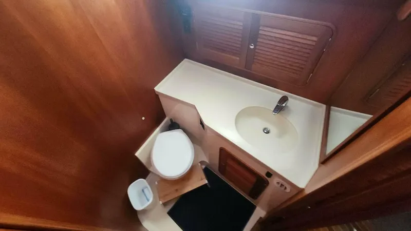 Slide: The Image of Hinckley Talaria 44 FB 2002 yacht bathroom with wooden cabinetry and compact design. - 16