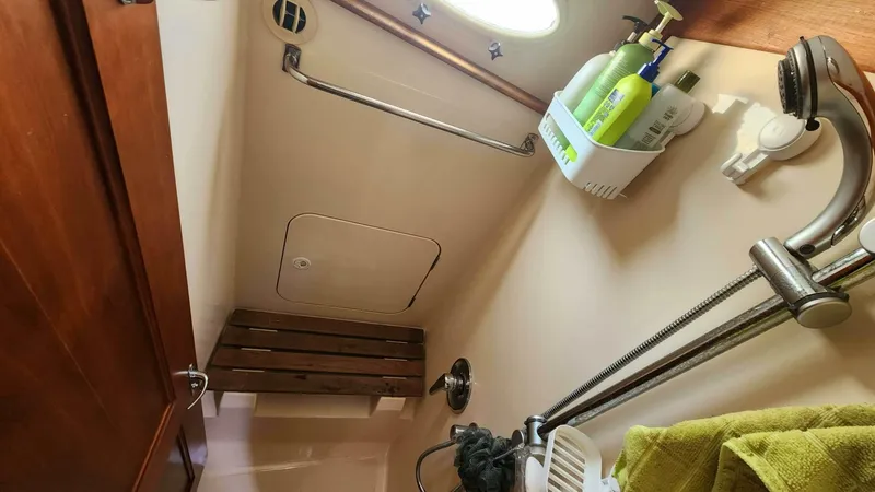 Slide: The Image of Hinckley Talaria 44 FB 2002 yacht bathroom with shower, wooden bench, and toiletries. - 17