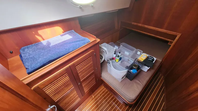Slide: The Image of Hinckley Talaria 44 FB 2002 cabin interior with wooden finish and organized storage. - 19