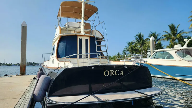 Slide: The Image of Hinckley Talaria 44 FB 2002 yacht "Orca" docked at marina with palm trees. - 2