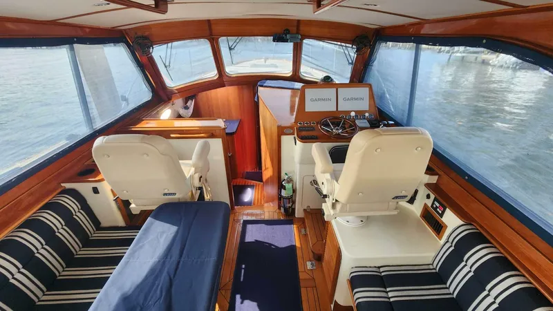 Slide: The Image of Interior of 2002 Hinckley Talaria 44 FB yacht with striped seating and navigation equipment. - 5