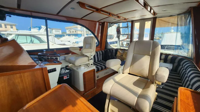 Slide: The Image of Interior of 2002 Hinckley Talaria 44 FB yacht with luxurious seating and wooden finishes. - 7