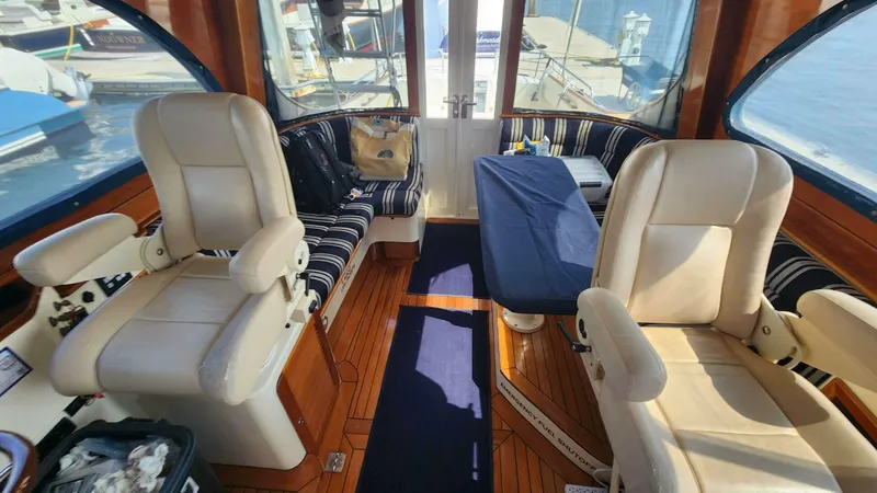 Slide: The Image of Interior of 2002 Hinckley Talaria 44 FB yacht with plush seating and wooden flooring. - 8