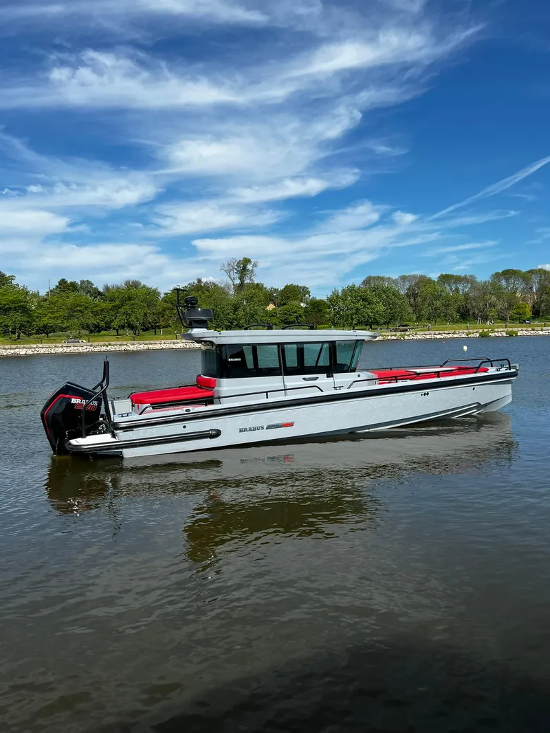 Slide: The Image of 2022 BRABUS Shadow 500 Cabin boat on a calm river under a blue sky. - 0