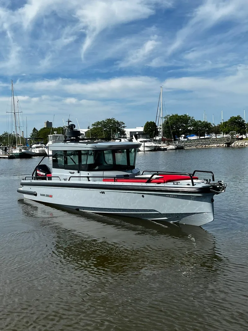 Slide: The Image of 2022 BRABUS Shadow 500 Cabin boat on calm water under a partly cloudy sky. - 1