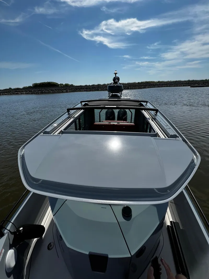 Slide: The Image of 2022 BRABUS Shadow 500 Cabin boat on calm water under a clear sky. - 10