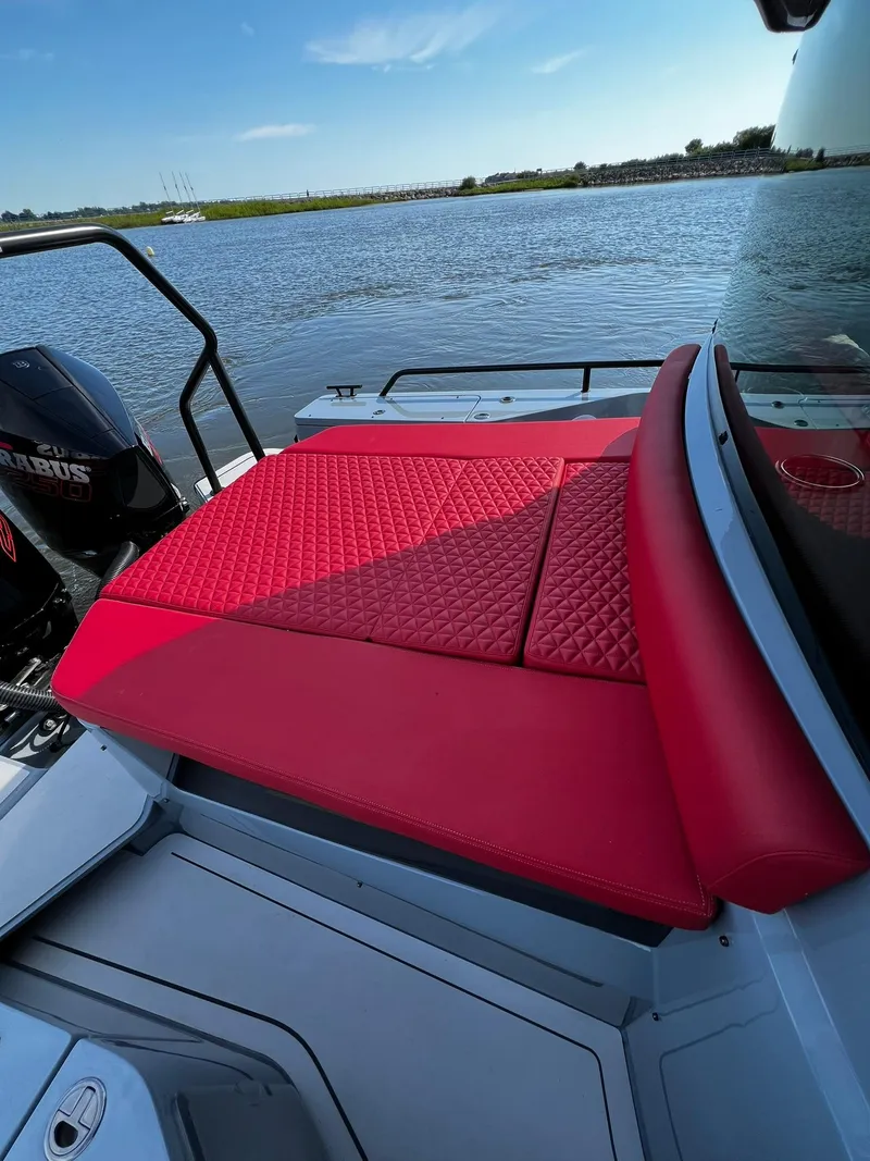 Slide: The Image of 2022 BRABUS Shadow 500 Cabin with red seating, on a calm lake. - 14