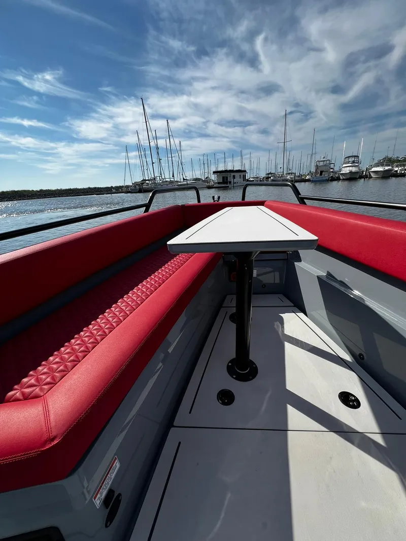 Slide: The Image of 2022 BRABUS Shadow 500 Cabin boat with red seating, docked in a marina. - 16