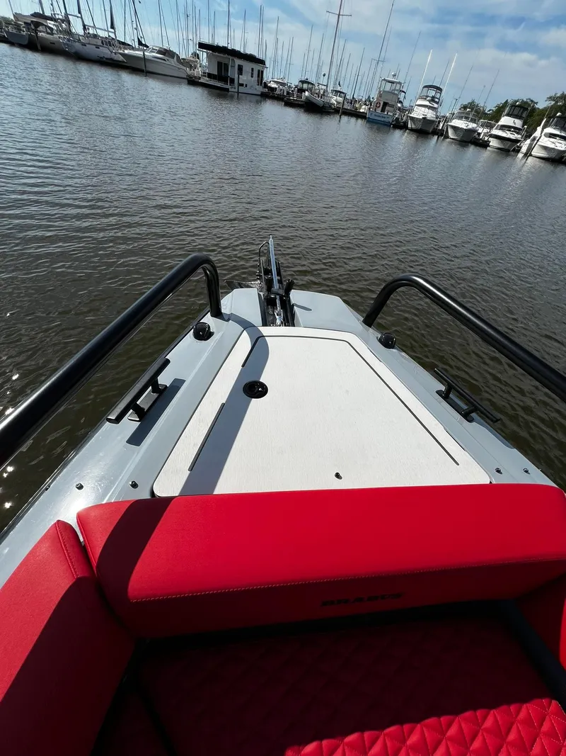 Slide: The Image of 2022 BRABUS Shadow 500 Cabin boat with red seating, docked in a marina. - 19