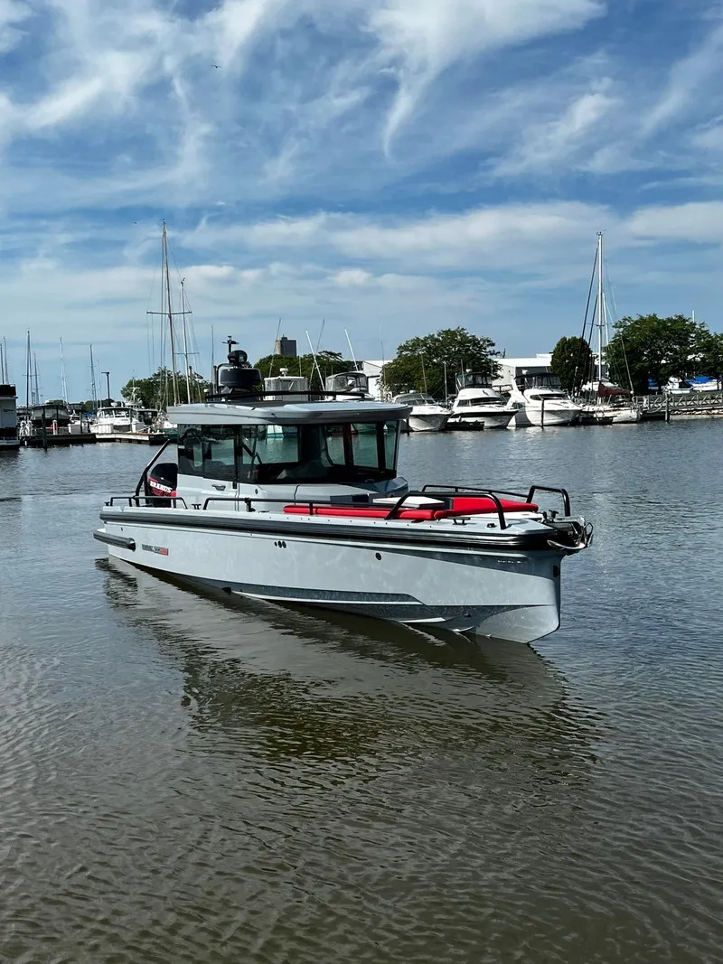 Slide: The Image of 2022 BRABUS Shadow 500 Cabin boat on calm water, with marina background. - 2
