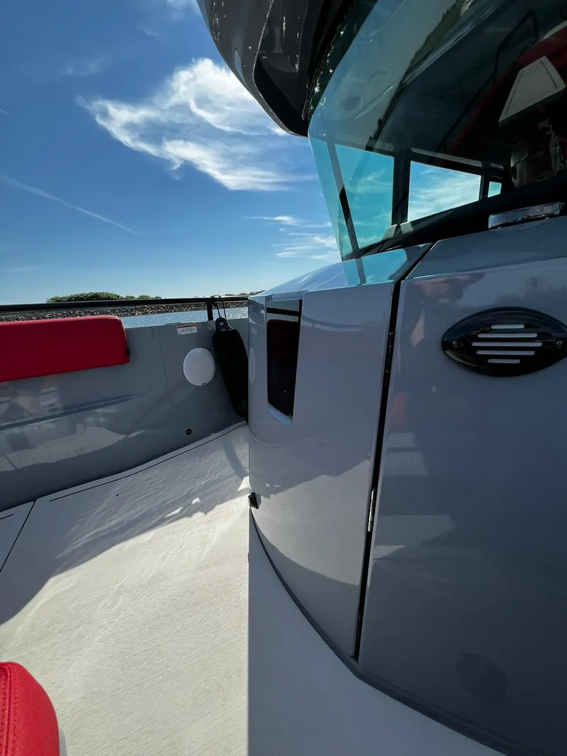 Slide: The Image of 2022 BRABUS Shadow 500 Cabin boat, sleek design, blue sky background. - 21