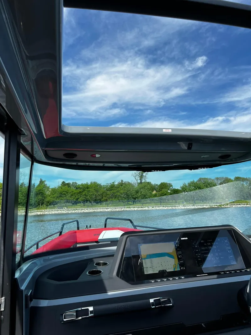 Slide: The Image of Interior view of 2022 BRABUS Shadow 500 Cabin boat with navigation display, under a clear sky. - 24