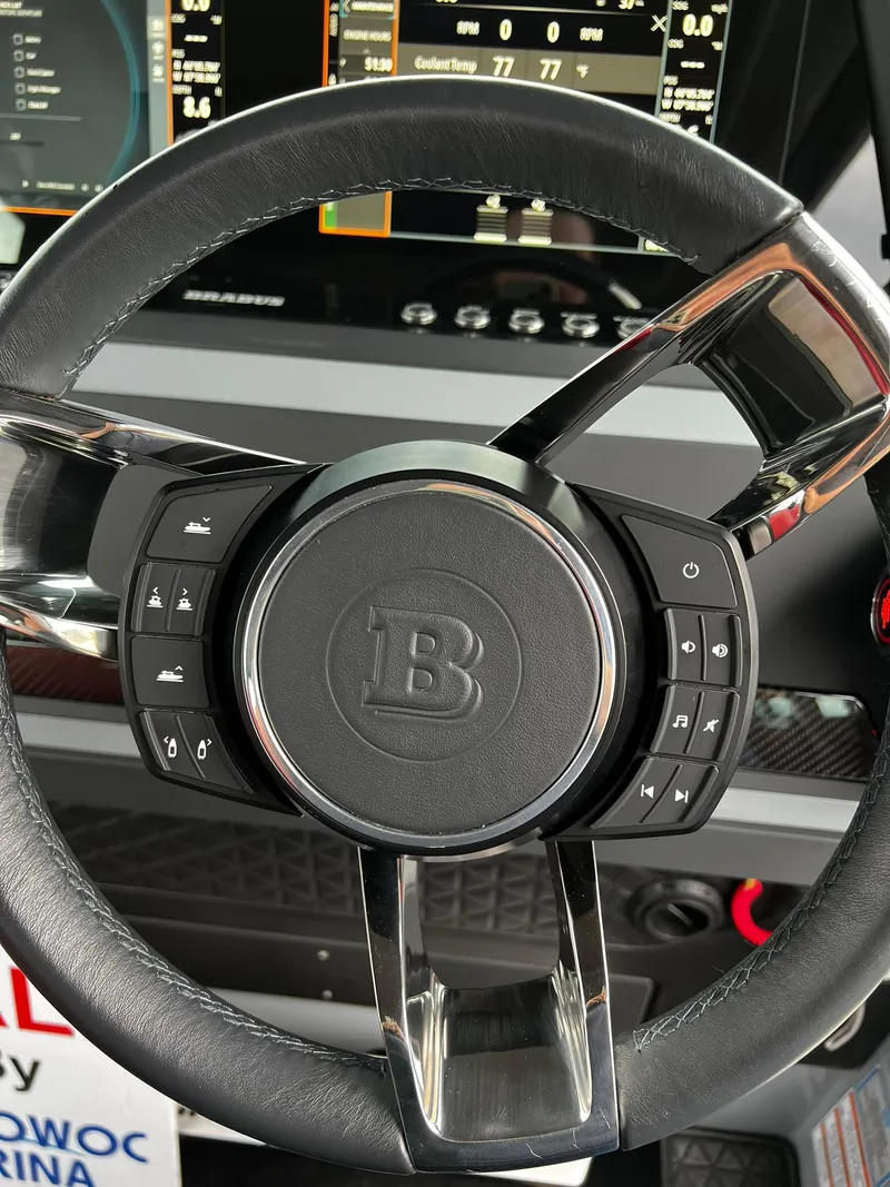 Slide: The Image of Steering wheel of 2022 BRABUS Shadow 500 Cabin with control buttons and display. - 29