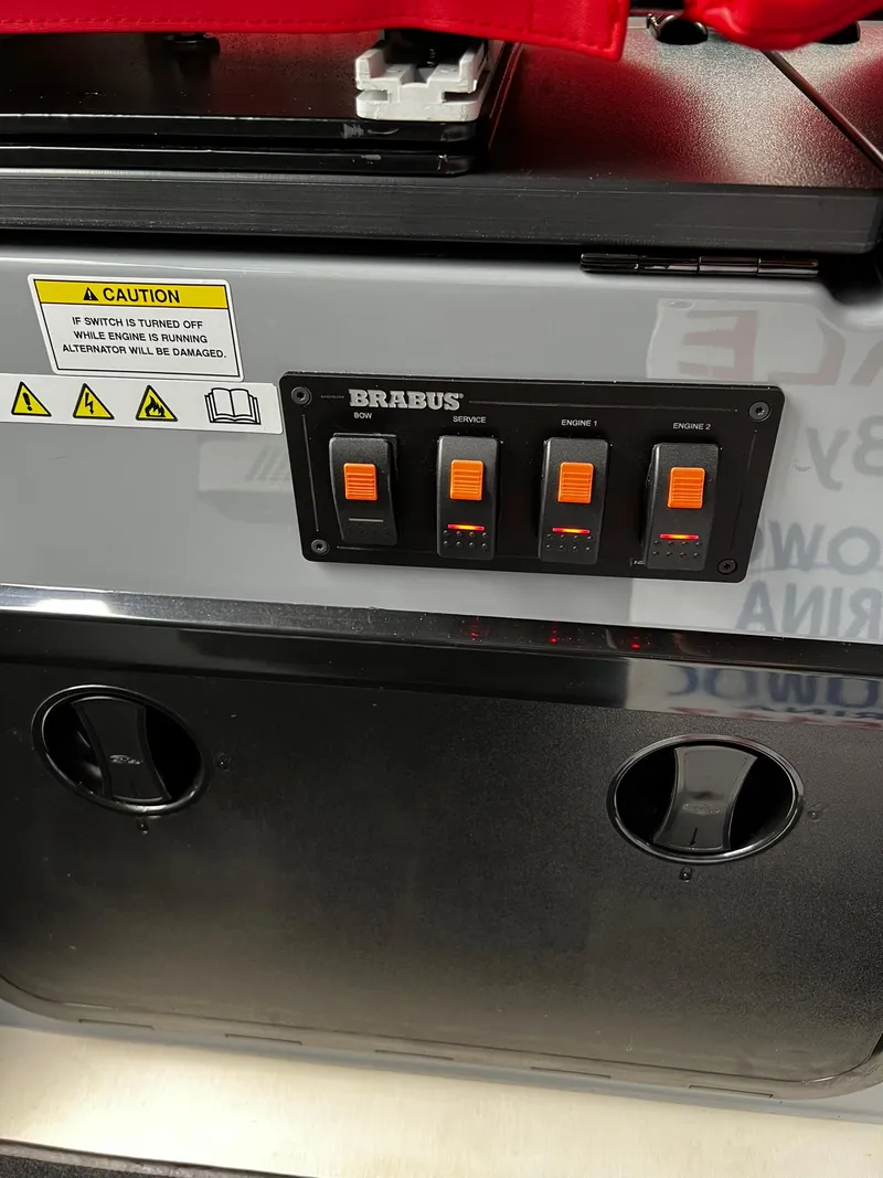 Slide: The Image of Control panel of 2022 BRABUS Shadow 500 Cabin with caution labels and switches. - 31