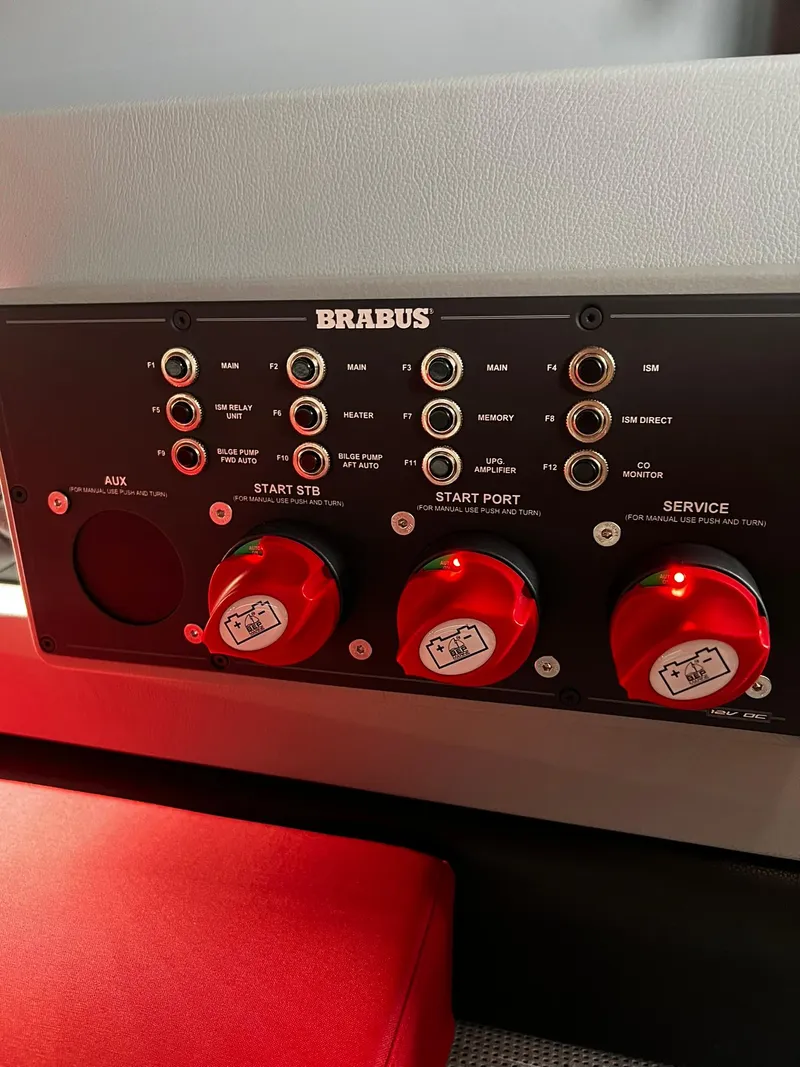 Slide: The Image of Control panel of 2022 BRABUS Shadow 500 Cabin with red switches and labeled ports. - 34