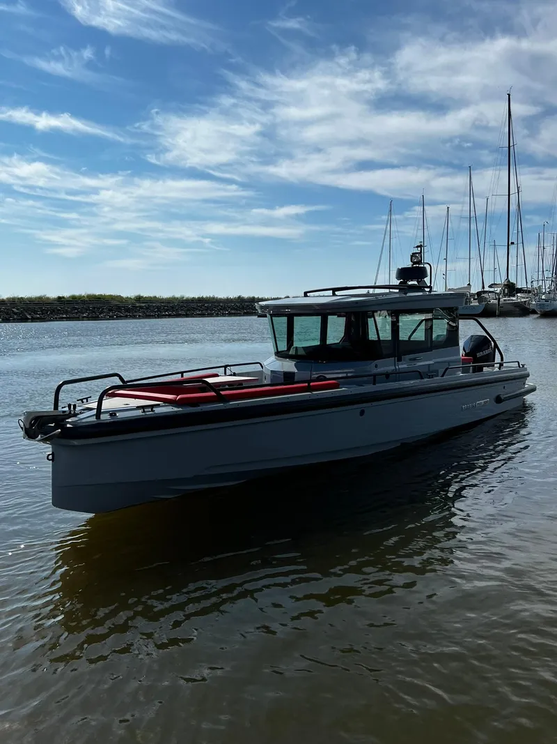 Slide: The Image of 2022 BRABUS Shadow 500 Cabin boat on calm water with a clear sky background. - 9