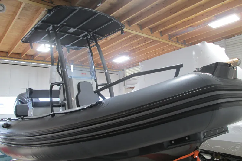Slide: The Image of 2025 Zodiac Pro 6.5 inflatable boat in a wooden-ceiling showroom. - 1