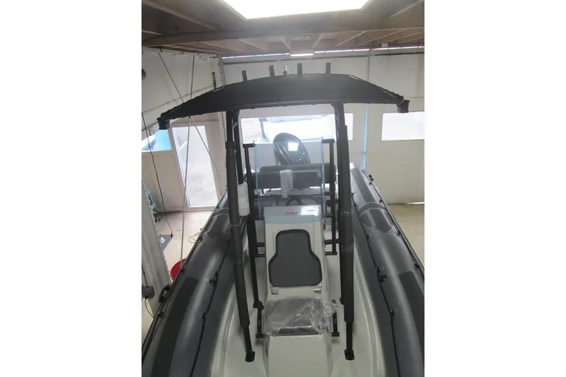Slide: The Image of 2025 Zodiac Pro 6.5 boat in indoor storage, featuring a sleek design and sturdy frame. - 10