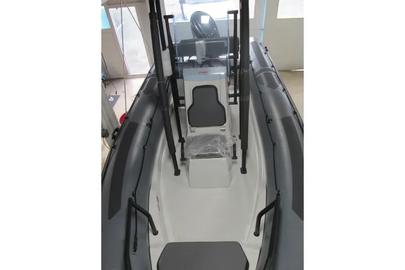 Slide: The Image of 2025 Zodiac Pro 6.5 boat interior with seating and control console. - 11