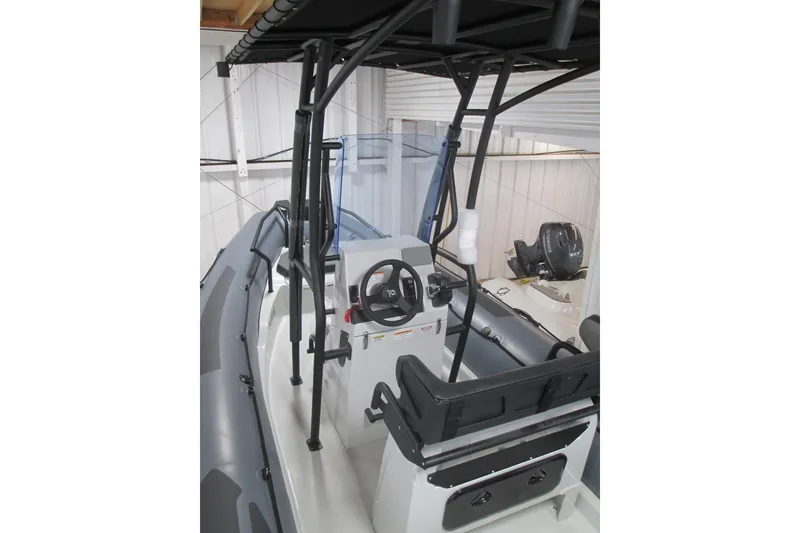 Slide: The Image of 2025 Zodiac Pro 6.5 boat interior with steering console and seating. - 4
