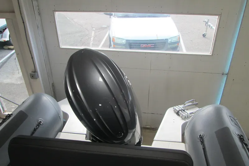 Slide: The Image of 2025 Zodiac Pro 6.5 boat engine in garage, viewed from above. - 6